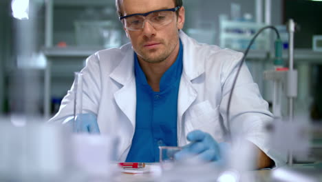 Scientist-in-lab-doing-medical-research.-Laboratory-worker-pour-liquid